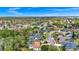 The home is centered between lush trees and other community homes, as seen from above at 2932 Bayhead Run, Oviedo, FL 32765