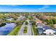 An aerial view looking down the street into the community showcases mature trees and beautiful landscaping at 2932 Bayhead Run, Oviedo, FL 32765