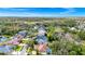 An aerial view looking over the neighborhood and home, surrounded by lush greenery at 2932 Bayhead Run, Oviedo, FL 32765