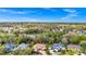 The house sits in a lush landscape with an incredible, treed backdrop, as seen from an aerial view at 2932 Bayhead Run, Oviedo, FL 32765