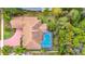 The aerial view of the backyard showcases the pool and verdant landscape at 2932 Bayhead Run, Oviedo, FL 32765
