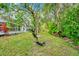 The backyard features lush green grass, mature trees, and a walking path at 2932 Bayhead Run, Oviedo, FL 32765