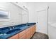 Bathroom featuring a double vanity with blue marble countertop and matching blue sinks, plus carpet flooring at 2932 Bayhead Run, Oviedo, FL 32765