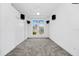 Carpeted bedroom featuring dual windows with neighborhood views, complemented by speakers and a ceiling fan at 2932 Bayhead Run, Oviedo, FL 32765