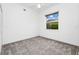 Cozy carpeted bedroom with a ceiling fan and a window offering natural light and neighborhood views at 2932 Bayhead Run, Oviedo, FL 32765