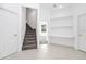 Hallway features stairs to the 2nd story and an alcove with built in shelves and a countertop at 2932 Bayhead Run, Oviedo, FL 32765