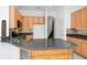 Kitchen island featuring granite countertop, cabinets, and stainless steel sink at 2932 Bayhead Run, Oviedo, FL 32765