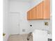 A laundry room has lots of storage space and utility sink at 2932 Bayhead Run, Oviedo, FL 32765