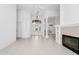 Bright, open living space featuring a fireplace, built-in shelving, and elegant tile flooring at 2932 Bayhead Run, Oviedo, FL 32765