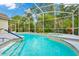 The screened-in pool has steps and a handrail for easy access at 2932 Bayhead Run, Oviedo, FL 32765