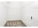 Spacious walk-in closet with neutral carpet and multiple built-in white wire shelves for optimal storage at 2932 Bayhead Run, Oviedo, FL 32765