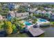 An aerial view of the community, pool, pier, and surrounding tropical landscape and residential buildings at 3002 Bonfire Beach Dr # 202, Kissimmee, FL 34746
