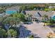 Community aerial view showing Runaway Bay Condominiums buildings, lake, and mature trees at 3002 Bonfire Beach Dr # 202, Kissimmee, FL 34746