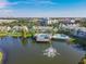 Community aerial view overlooking a lake, fountain, pools, pier, and tropical landscape at 3002 Bonfire Beach Dr # 202, Kissimmee, FL 34746