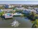 Panoramic aerial shot showcases the community pools, pier, and tropical landscape with waterfront views at 3002 Bonfire Beach Dr # 202, Kissimmee, FL 34746