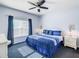 Bedroom with a queen bed, ceiling fan, and natural light from a window at 3002 Bonfire Beach Dr # 202, Kissimmee, FL 34746