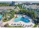 Inviting community pool with a splash area for , surrounded by palm trees and lounge chairs at 3002 Bonfire Beach Dr # 202, Kissimmee, FL 34746