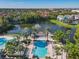 Aerial image showcases community pools, serene lake with fountain, and tropical landscaping at 3002 Bonfire Beach Dr # 202, Kissimmee, FL 34746