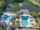Picturesque community pools with a serene lake and fountain, providing a resort-style living experience at 3002 Bonfire Beach Dr # 202, Kissimmee, FL 34746
