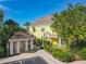 Exterior view of a yellow condo building with well-maintained landscaping and a mailbox kiosk at 3002 Bonfire Beach Dr # 202, Kissimmee, FL 34746