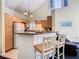 Cozy kitchen with breakfast bar, white appliances, and bright cabinets at 3002 Bonfire Beach Dr # 202, Kissimmee, FL 34746
