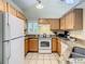 Bright kitchen with granite countertops, white appliances, and ample cabinet space at 3002 Bonfire Beach Dr # 202, Kissimmee, FL 34746