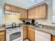 Kitchen with stainless steel sink, granite counters, and white appliances at 3002 Bonfire Beach Dr # 202, Kissimmee, FL 34746
