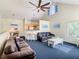 Bright living room features a large ceiling fan, comfortable sofas, and a modern kitchenette at 3002 Bonfire Beach Dr # 202, Kissimmee, FL 34746