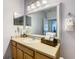Bathroom vanity with a mirror, lighting, and a towel ring at 3002 Bonfire Beach Dr # 202, Kissimmee, FL 34746