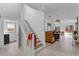 Hallway with white stairway leading to an open-concept living space at 3007 E Central Blvd # 3007, Orlando, FL 32803