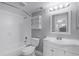 Well-lit bathroom with a shower-tub combo, cabinet storage, and vanity mirror at 305 Lakepointe Dr # 103, Altamonte Springs, FL 32701