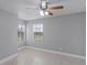 Bright bedroom with tile floors, ceiling fan, and large windows at 305 Lakepointe Dr # 103, Altamonte Springs, FL 32701