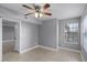 Neutral bedroom featuring tile floors, a ceiling fan, and large windows at 305 Lakepointe Dr # 103, Altamonte Springs, FL 32701