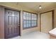 Condo front door featuring neutral walls, and a view through the window at 305 Lakepointe Dr # 103, Altamonte Springs, FL 32701