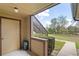 Exterior view from a condo's outdoor patio featuring a stairwell, small landscaping, and a glimpse of community greenery at 305 Lakepointe Dr # 103, Altamonte Springs, FL 32701