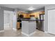 Well-lit kitchen featuring stainless steel appliances, wood cabinetry, and an open layout adjacent to the living area at 305 Lakepointe Dr # 103, Altamonte Springs, FL 32701