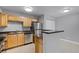 Functional kitchen featuring stainless steel appliances, wood cabinets, breakfast bar, and tiled flooring for easy maintenance at 305 Lakepointe Dr # 103, Altamonte Springs, FL 32701