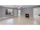 Open-concept living space with neutral paint, tile floors, fireplace and a view of the front door at 305 Lakepointe Dr # 103, Altamonte Springs, FL 32701