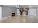 Open-concept living room with a cozy fireplace and seamless transition into the kitchen, all enhanced by neutral paint at 305 Lakepointe Dr # 103, Altamonte Springs, FL 32701
