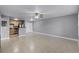 Spacious living room with tile flooring, neutral walls, ceiling fan, and an open layout leading to the kitchen at 305 Lakepointe Dr # 103, Altamonte Springs, FL 32701
