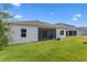 Home's exterior showcases a spacious, well-maintained backyard and screened-in patio at 3186 Sailing Pier Ave, Winter Garden, FL 34787