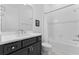 Bright bathroom features a shower and tub combo, stylish vanity and mirror at 3186 Sailing Pier Ave, Winter Garden, FL 34787