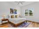Bright bedroom features a ceiling fan, a window with a view and stylish decor at 3186 Sailing Pier Ave, Winter Garden, FL 34787