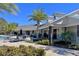 Inviting clubhouse with outdoor seating, palm trees, and manicured landscaping for community enjoyment at 3186 Sailing Pier Ave, Winter Garden, FL 34787