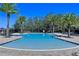 Inviting community pool surrounded by palm trees and lounge chairs for relaxation at 3186 Sailing Pier Ave, Winter Garden, FL 34787