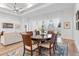 Elegant dining room featuring hardwood floors, a modern ceiling fan, and access to the backyard at 3186 Sailing Pier Ave, Winter Garden, FL 34787