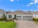 Charming home with a well-manicured lawn, beautiful landscaping, and a three car garage at 3186 Sailing Pier Ave, Winter Garden, FL 34787