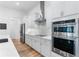 Well-equipped kitchen with stainless steel appliances, white cabinets, and modern backsplash at 3186 Sailing Pier Ave, Winter Garden, FL 34787
