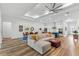 Spacious living room with a modern ceiling fan, hardwood floors, and an open floor plan at 3186 Sailing Pier Ave, Winter Garden, FL 34787