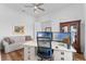 Spacious office featuring hardwood floors, a large desk, and a comfortable seating area at 3186 Sailing Pier Ave, Winter Garden, FL 34787